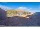 Spacious backyard with dirt and a fence, perfect for landscaping and outdoor activities with mountain views at 21422 W Meadowbrook Ave, Buckeye, AZ 85396