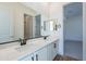 Bathroom with double sinks, white cabinets, and black hardware at 21422 W Meadowbrook Ave, Buckeye, AZ 85396
