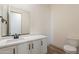Modern bathroom with a white vanity, quartz countertop, and trendy fixtures at 21422 W Meadowbrook Ave, Buckeye, AZ 85396