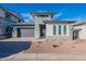 Beautiful single-story home featuring a gray exterior, gray garage door, desert landscaping and a paver driveway at 21422 W Meadowbrook Ave, Buckeye, AZ 85396