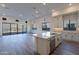 Bright kitchen with island and stainless steel appliances and access to the backyard at 21422 W Meadowbrook Ave, Buckeye, AZ 85396