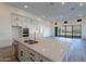 Kitchen island featuring a sink with views of a mountain range through the large window at 21422 W Meadowbrook Ave, Buckeye, AZ 85396