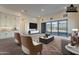 Staged living room with a mountain view out the sliding glass doors and tile flooring at 21422 W Meadowbrook Ave, Buckeye, AZ 85396