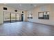Living room with tile flooring, sliding glass doors to the back patio, and various windows for natural light at 21422 W Meadowbrook Ave, Buckeye, AZ 85396