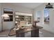 Virtually Staged Office with large desk and shelving unit at 21422 W Meadowbrook Ave, Buckeye, AZ 85396