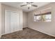 This bedroom features neutral walls and a ceiling fan at 2223 W 8Th Ave, Mesa, AZ 85202
