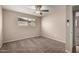 This bedroom has neutral walls, a ceiling fan, and a window at 2223 W 8Th Ave, Mesa, AZ 85202