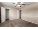 The bedroom has neutral walls, a ceiling fan, and closet with sliding doors at 2223 W 8Th Ave, Mesa, AZ 85202