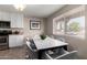 Bright dining area with a marble table, gray chairs, and natural light from the window at 2223 W 8Th Ave, Mesa, AZ 85202