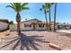 Charming single-story home featuring desert landscaping, a covered porch, and mature palm trees at 2223 W 8Th Ave, Mesa, AZ 85202