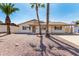Charming single-story home featuring desert landscaping, a covered porch, and mature palm trees at 2223 W 8Th Ave, Mesa, AZ 85202