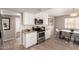 Updated kitchen with modern appliances, white cabinets, and a view into the dining area at 2223 W 8Th Ave, Mesa, AZ 85202