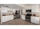 Bright, updated kitchen features white cabinets, stainless steel appliances, and modern tile flooring at 2223 W 8Th Ave, Mesa, AZ 85202