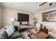 Cozy living room featuring a large TV, comfortable seating, and a modern coffee table at 2223 W 8Th Ave, Mesa, AZ 85202