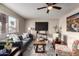 Inviting living room featuring a plush gray sofa, stylish chairs, and a modern ceiling fan at 2223 W 8Th Ave, Mesa, AZ 85202