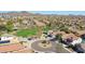 Panoramic aerial shot showcasing the residential area with a lush park, a central roundabout, and scenic mountains at 2411 W Oberlin Way, Phoenix, AZ 85085