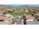 Expansive aerial view of a vibrant community with well-maintained homes, green spaces, and mountain views at 2411 W Oberlin Way, Phoenix, AZ 85085