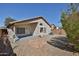 Backyard showcasing a covered patio, low-maintenance gravel landscaping, and privacy wall at 2411 W Oberlin Way, Phoenix, AZ 85085