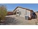 Backyard view of a low-maintenance gravel yard with a covered patio and a block wall for privacy at 2411 W Oberlin Way, Phoenix, AZ 85085