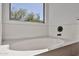 Close up of a soaking tub with a black faucet and window offering exterior views at 2411 W Oberlin Way, Phoenix, AZ 85085