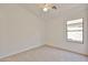 Bedroom with neutral carpet, a ceiling fan, and a window providing natural light at 2411 W Oberlin Way, Phoenix, AZ 85085