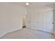 Bedroom with neutral carpet, closet with sliding doors, ceiling fan, and a doorway leading to another room at 2411 W Oberlin Way, Phoenix, AZ 85085