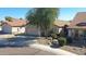 Street view of a single-story house with mature trees and a well-kept front yard at 2411 W Oberlin Way, Phoenix, AZ 85085