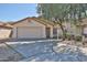Charming single-story home with a two-car garage and low-maintenance front yard at 2411 W Oberlin Way, Phoenix, AZ 85085