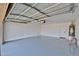 Clean garage with epoxy flooring, ample space, and a door leading to the house at 2411 W Oberlin Way, Phoenix, AZ 85085