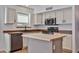 Bright kitchen featuring white cabinets, stainless steel appliances, and a butcher block island at 2411 W Oberlin Way, Phoenix, AZ 85085
