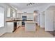 Well-lit kitchen with white cabinets, island, and stainless steel appliances at 2411 W Oberlin Way, Phoenix, AZ 85085