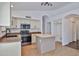 Bright kitchen featuring white cabinets, stainless steel appliances, and a center island at 2411 W Oberlin Way, Phoenix, AZ 85085