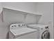 Functional laundry room featuring both a washing machine and a dryer for convenience at 2411 W Oberlin Way, Phoenix, AZ 85085