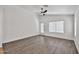 Bright living room with wood floors, natural light, and a ceiling fan at 2411 W Oberlin Way, Phoenix, AZ 85085