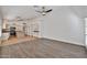 Spacious living room that features durable wood flooring and provides seamless access to the kitchen at 2411 W Oberlin Way, Phoenix, AZ 85085
