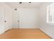 This bedroom features white walls, wood floors, closet and a window with shutter style blinds at 2938 N 15Th Ave, Phoenix, AZ 85015