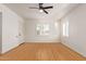 Bedroom featuring hardwood floors, ceiling fan, and a bright window at 2938 N 15Th Ave, Phoenix, AZ 85015