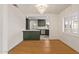 Dining room with hardwood floors, modern light fixture, and kitchen view at 2938 N 15Th Ave, Phoenix, AZ 85015