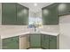 Bright kitchen featuring green cabinets, corner window, and stainless steel appliances at 2938 N 15Th Ave, Phoenix, AZ 85015