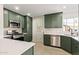 Modern kitchen with green cabinets, stainless steel appliances, quartz countertops and white subway tile backsplash at 2938 N 15Th Ave, Phoenix, AZ 85015