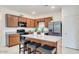 Charming kitchen featuring stainless steel appliances, granite counters, wood cabinets, and a central island with seating at 3010 N Majestic Ct, Casa Grande, AZ 85122