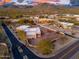 Desert property featuring mountain views, mature landscaping, gated entry, and neighboring houses at 37015 N 27Th Pl, Cave Creek, AZ 85331