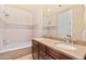 Elegant bathroom featuring double sinks, granite countertops, and a tiled tub and shower at 37015 N 27Th Pl, Cave Creek, AZ 85331