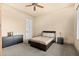 A cozy bedroom with a neutral color scheme and carpet floors. The furniture includes a dresser and nightstand at 37015 N 27Th Pl, Cave Creek, AZ 85331