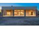 Rear exterior view of the home featuring a covered patio with stone pillars and desert landscaping at 37015 N 27Th Pl, Cave Creek, AZ 85331