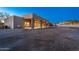Wide angle exterior view of the home featuring a covered patio with stone pillars and desert landscaping at 37015 N 27Th Pl, Cave Creek, AZ 85331