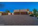 Large, stately desert home with two-car garage and stone accent, set in a brick paved driveway at 37015 N 27Th Pl, Cave Creek, AZ 85331