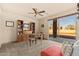 Inviting home office with built-in shelving, ceiling fan, and large window offering abundant natural light at 37015 N 27Th Pl, Cave Creek, AZ 85331