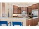 Modern kitchen with granite countertops, dark wood cabinets, and stainless steel appliances at 37015 N 27Th Pl, Cave Creek, AZ 85331
