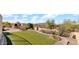 Panoramic view of the backyard showcasing the artificial turf, desert landscaping, and outdoor pizza oven at 40108 N 2Nd Way, Phoenix, AZ 85086
